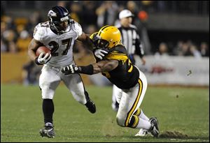 Steelers defensive end Ziggy Hood (96) tackles Ravens running back Ray Rice (27) during the second quarter Sunday.