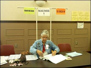 Barbara Steagall works Tuesday at a polling locaiton inside the Maumee Branch Library.
