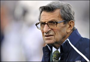 Penn State coach Joe Paterno stands on the field before his team's NCAA college football game against Northwestern last month in Evanston, Ill.