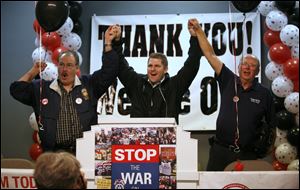 Bill Lichtenwald, president of Teamsters Local 20, left, State Rep. Matt Szollosi, center, and George Tucker, executive director of the Greater Northwest Ohio AFL-CIO celebrate the defeat of State Issue 2, at the Teamsters Hall in Toledo.