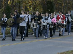 Percussionists from the Northview band lead the bus carrying the Northview girls' cross country team as they are bid farewell.