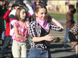 Grace Barcum, 9, and Elizabeth Lunsford, 9 dance the Macarena during Harvest Day at Wayne Trail School.