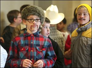 Ten-year-old Logan Moore wears a coon skin hat  and a mustache during Harvest Day at Wayne Trail School in Maumee.