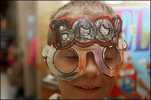 First grader Griffin Wolf, 6, wears a mask he made in class.
