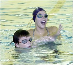 Stingray swimmers Brendan Varnes, left, and Meegan Smith share a laugh in between laps during practice.