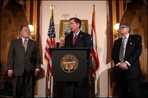 Ohio Senate president John Niehaus, left, Gov. John Kasich, center, and House Speaker William Batchelder talk in Columbus, Ohio, after the state's new collective bargaining law was defeated following an expensive union-backed campaign that pitted firefighters, police officers and teachers against the Republican establishment.