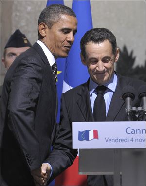 President Obama and French President Nicolas Sarkozy shake hands during the G20 summit. An open microphone caught Mr. Sarkozy criticizing, and Mr. Obama apparently not defending, Israel's prime minister.