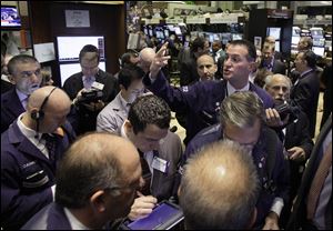 Trader Jonathan Corpina, right center, works Wednesday on the floor of the New York Stock Exchange.