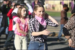 Grace Barcum, 9, and Elizabeth Lunsford, 9 dance the Macarena during Harvest Day at Wayne Trail School.