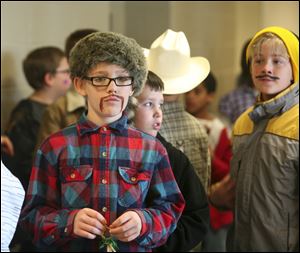 Ten-year-old Logan Moore wears a coon skin hat  and a mustache during Harvest Day at Wayne Trail School in Maumee.