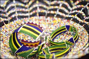 These bracelets are made with beads patterned to look like the flag of Tanzania.