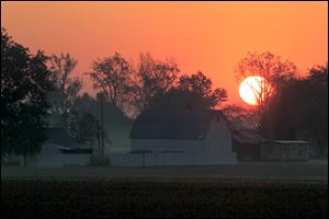 The sun rises over a farm in LaSalle, Mich., last week.
