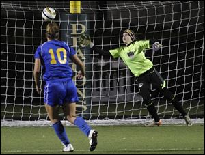 St. Ursula's Kiley Armstrong kicks the winning goal in a sudden-death shootout against Cuyahoga Falls Walsh Jesuit goalkeeper Caitlin Jakubek in Wednesday night's Division II state semifinal.