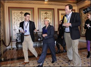 Supercommittee co-chair Sen. Patty Murray, D-Wash., center, is pursued Wednesday by reporters on Capitol Hill in Washington as she arrives for a closed-door session with fellow Democrats of the deficit panel.