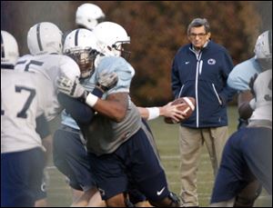 Coach Joe Paterno keeps an eye on a drill during practice Wednesday as the scandal of child abuse charges swirled around campus.