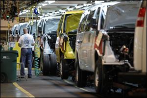 General Motors rolls along at plants such as this assembly line in Wentzville, Mo., but third-quarter profits fell 15 percent from a year ago because of weak earnings in other parts of the world.