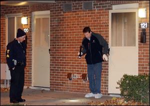 Police at the scene of a double shooting at 121 Ravine Park Village in Toledo.