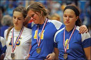 St. Ursula teammates, from left, Emma Romstadt, Katie Felix and Erin Williams are not smiling after losing the championship game of the OHSAA Div. I girls state volleyball tournament to Mount Notre Dame.