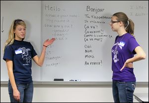 Hannah Bakies, 16, and Jane Chernykh, 15, teach the french language to kids during the Free French Language Kids' Clinic.