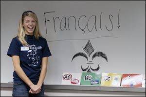 Perrysburg High School French Club member Hannah Bakies teaches the french language to children at the Way Public Library in Perrysburg.