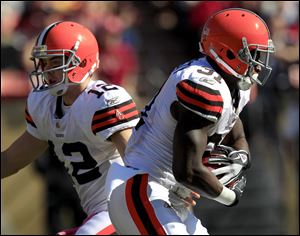 Cleveland Browns running back Montario Hardesty (31) takes a handoff from quarterback Colt McCoy (12) in the first quarter of an NFL football game against the San Francisco 49ers.