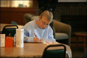 Darlene Kennedy takes notes during the safety program at Sylvania Senior Center.