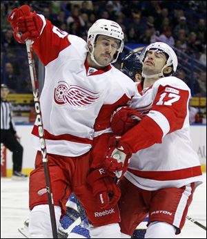 Detroit Red Wings' Drew Miller, left, and Patrick Eaves collide while chasing a loose puck during the first period of an NHL hockey game against the St. Louis Blues Tuesday.
