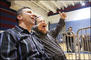 Ed Plocek, left, and brother Tony Plocek shout encouragement and instructions during a wrestling match at Springfield High School in Holland, Ohio.