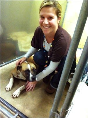 Gretel, a boxer mix, is shown with Melissa Hagemann, office manager at the Maumee Bay Veterinary Hospital in Oregon, Ohio.