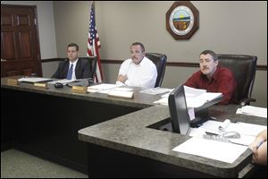 County Commissioners Ben Nutter, left, David Sauber, center, and Jeff Wagner, right, listen to citizens discuss the demolition bid for the Seneca County Courthouse.