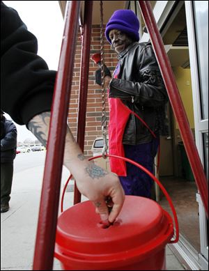 Mike Perry, Toledo, rings the bell for the Salvation Army's Red Kettle campaign at the Wal Mart in Oregon.