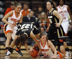 BG’s Jessica Slagle battles Purdue’s KK Houser for a loose ball Thursday as the Falcons nearly beat the 16th-ranked Boilermakers.