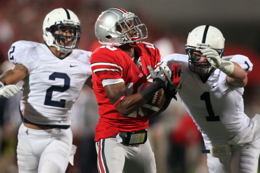 OSU-receiver-Corey-Brown-can-t-hold-onto-the-ball-with-Penn-State-defenders-in-pursuit