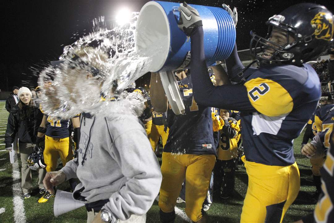 Whitmer-coach-Joe-Palka-gets-doused-in-water-after-Whitmer-won-the-regional-title