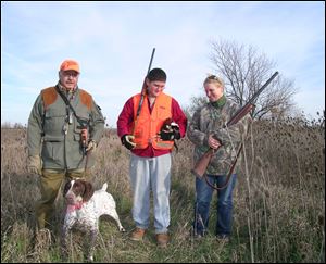 Instructor Rick Lopez, left, Jason Adams, and Gretchen Kruse join forces in a 'Wingshooting 101' pheasant hunting experience.