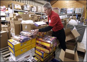 Bob Osborn unpacks toys at the Meijer in Rossford, where groups of inventory are set aside for Black Friday selling.