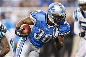 Detroit Lions running back Kevin Smith runs the ball for a touchdown in the fourth quarter of an NFL football game against the Carolina Panthers in Detroit, Sunday.