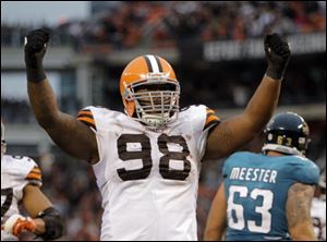 Cleveland Browns defensive tackle Phillip Taylor (98) celebrates as time runs out in the Browns' 14-10 win over the Jacksonville Jaguars in an NFL football game Sunday in Cleveland.