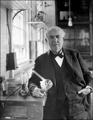 Thomas Alva Edison, holds his 