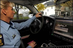 Toledo police Officer Tanja Farrell patrols the 1100 block of Fernwood Avenue, near the home of Justin Smith. He was killed during a vigil for another homicide victim.