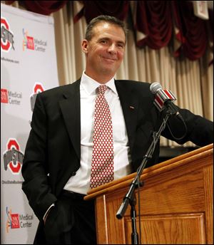 Former Bowling Green coach Urban Meyer addresses the media after being introduced as Ohio State’s new coach. He obtained his master’s degree from OSU in 1988 and was an assistant under Earle Bruce.