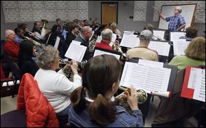 Fred Dais conducts during a rehearsal of the Owens Concert Band shortly after it was formed in January, 2010. Made up of students and community members, the band will perform Sunday in the Mainstage Theatre on campus.