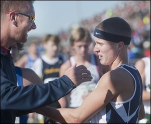 Napoleon’s Steve Weaver is congratulated by assistant coach Jeff Ressler after winning the Division II state title.