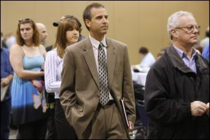 Dave Waganfeald of Temperance, Mich., waits in line at a job fair in Toledo. A Federal Reserve survey says overall hiring remains weak. Roughly 14 million people were unemployed in October.