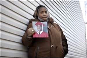 Tonya Patterson, Tyrone Patterson's aunt, shows a picture of him. She speculated Wednesday that he died in a robbery gone wrong. 