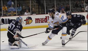 The Walleye's Trevor Parkes scores against Chicago goaltender Rob Nolan. Parkes' first goal as a pro was the game winner for Toledo