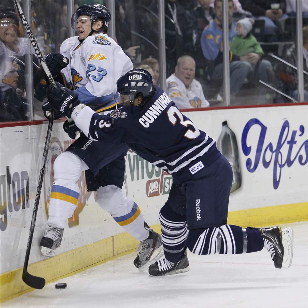 Walleye-player-Byron-Froese-23-is-hit-by-Greenville-Warriors-player-Wes-Cunningham