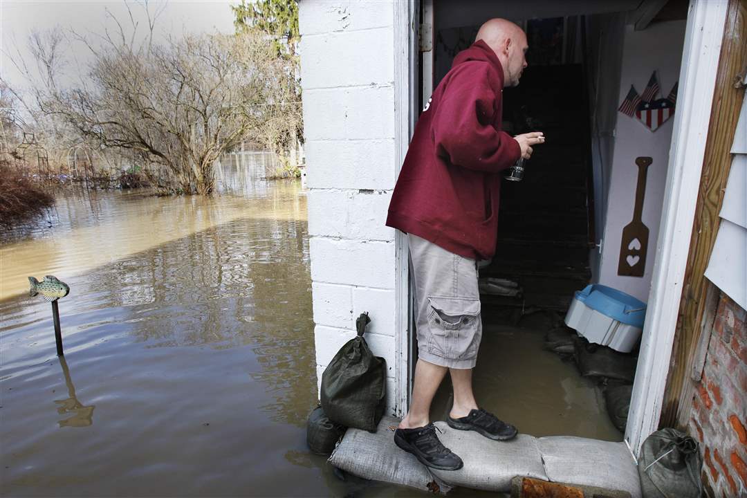 W-Monroe-St-resident-Nick-Polley-monitors-flood-waters