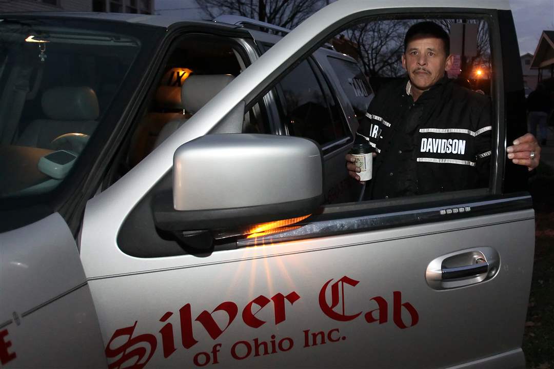 Adrian-Garcia-owner-of-Silver-Cab-of-Ohio-gets-into-his-cab-during-a-vigil-for-Scott-Holzhauer