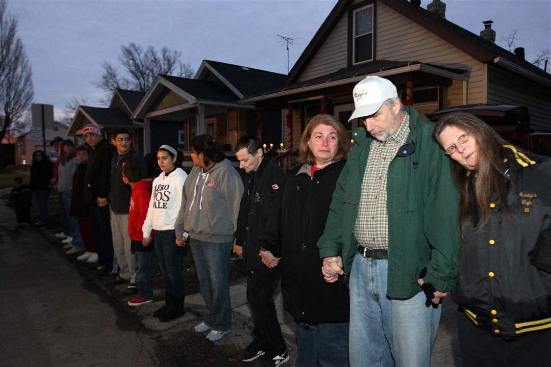 Family-and-friends-of-Scott-Holzhauer-line-the-street-during-a-vigil-Saturady